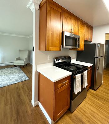 a kitchen with stainless steel appliances and wooden cabinets
